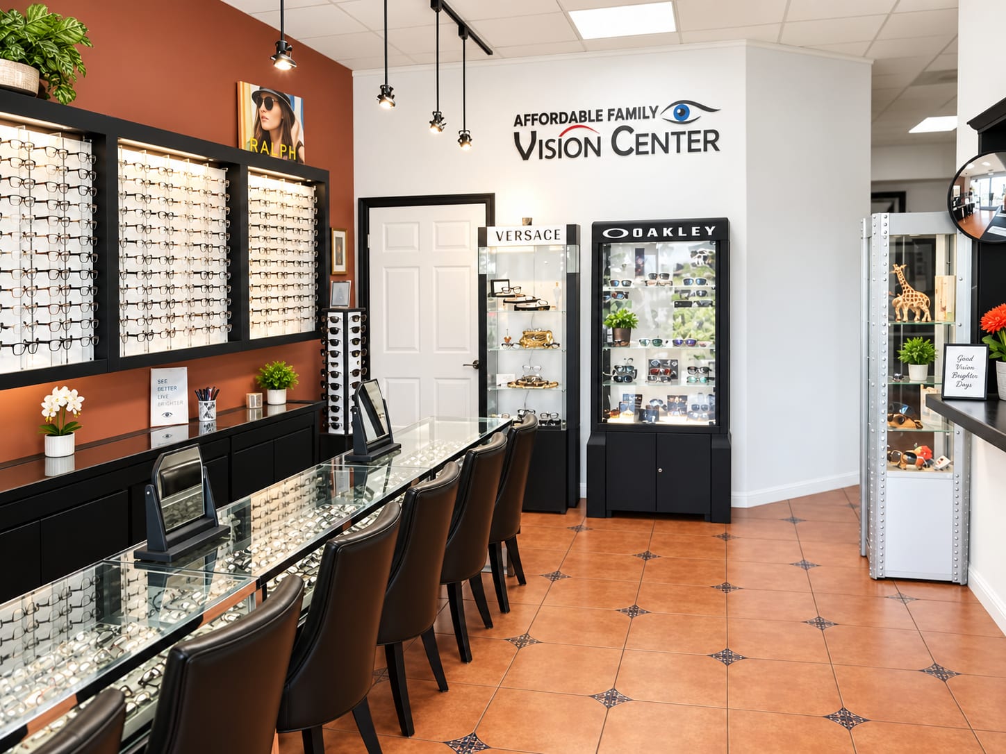 The optical floor at Affordable Family Vision Center: lit frame displays along a terracotta wall, a glass counter with fitting mirrors and chairs, and Versace and Oakley cases beneath the practice sign.
